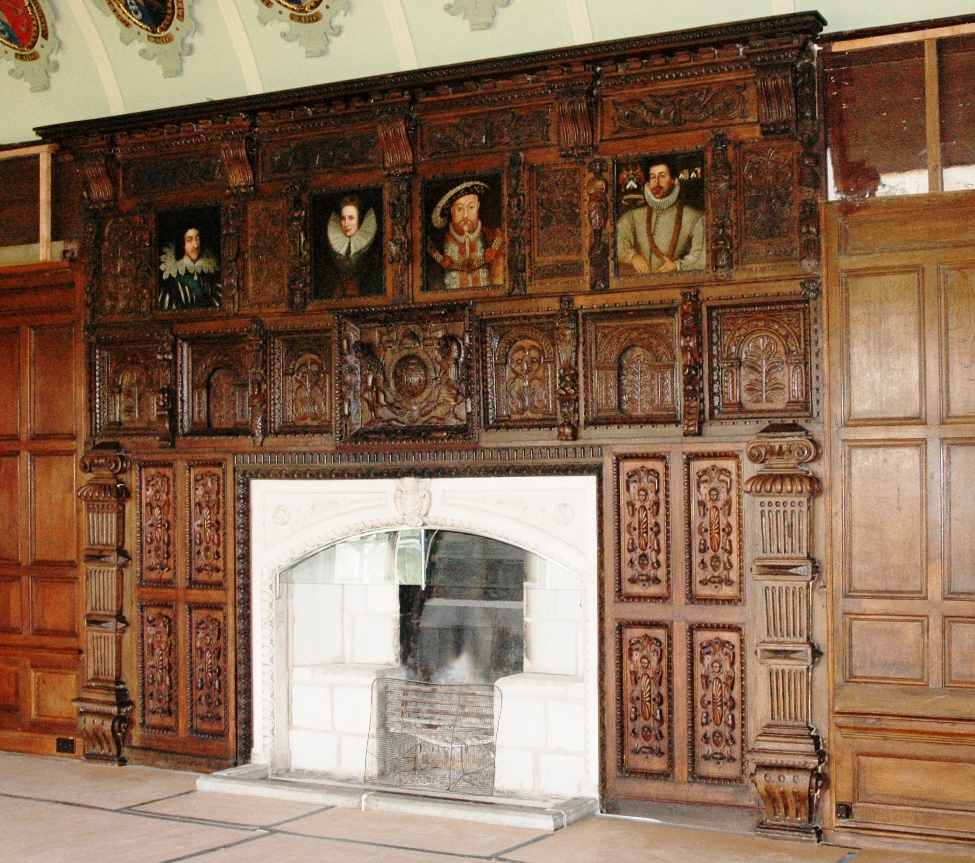 Portraits inset around the fireplace of the Combermere library