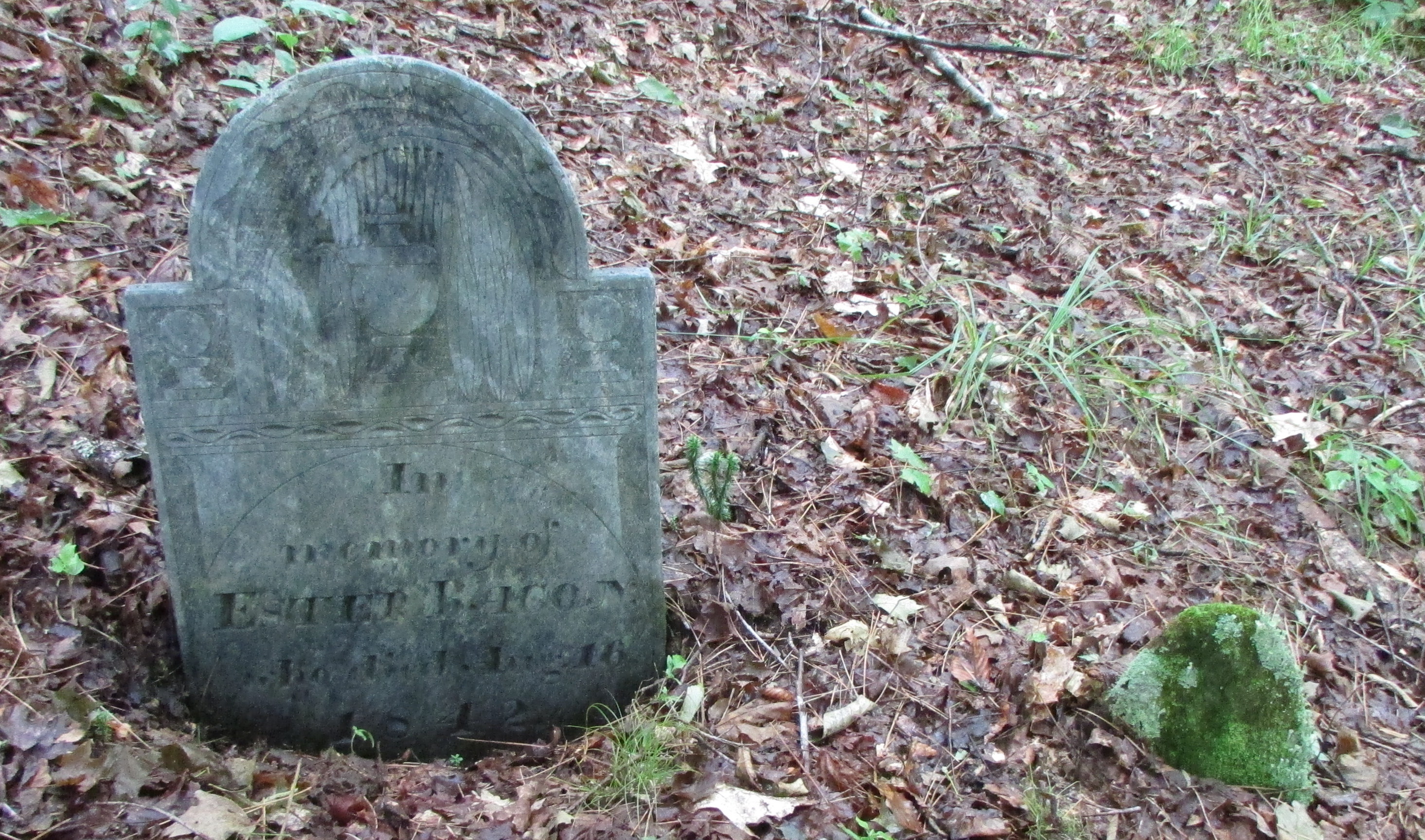Gravestone of Esther (Elmer) Bacon, next to a possible unmarked child's stone