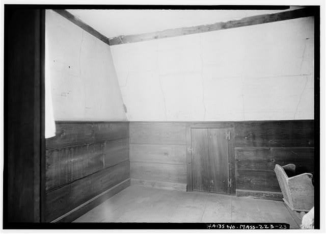 Photograph of a bedroom with a wood closet in the Fairbanks House