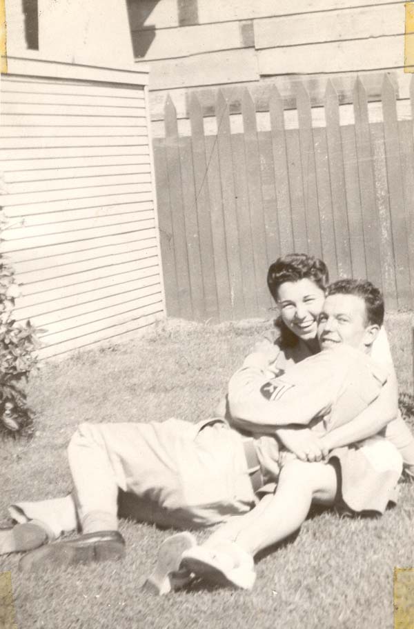 Frank and Florence, sitting on a lawn and cuddled together