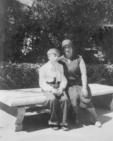Frank in his early teens sitting with Bertha on a bench