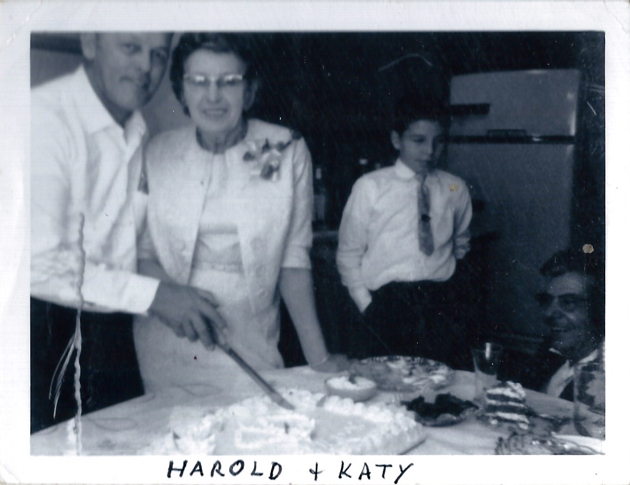 Harold and Katie Silker cutting their wedding cake with Darryl Boyd and Dante Dorato nearby