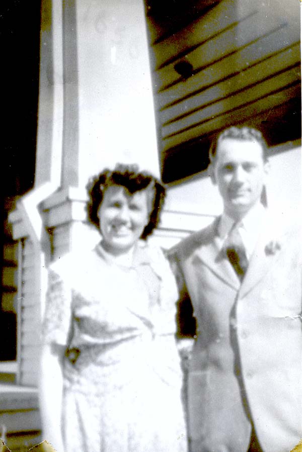 Mary and Joe Fettig in front of a house