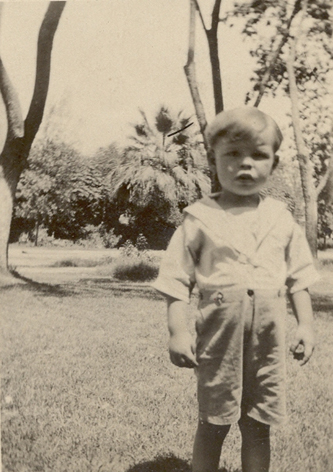 Frank Boyd as a toddler, standing on a lawn