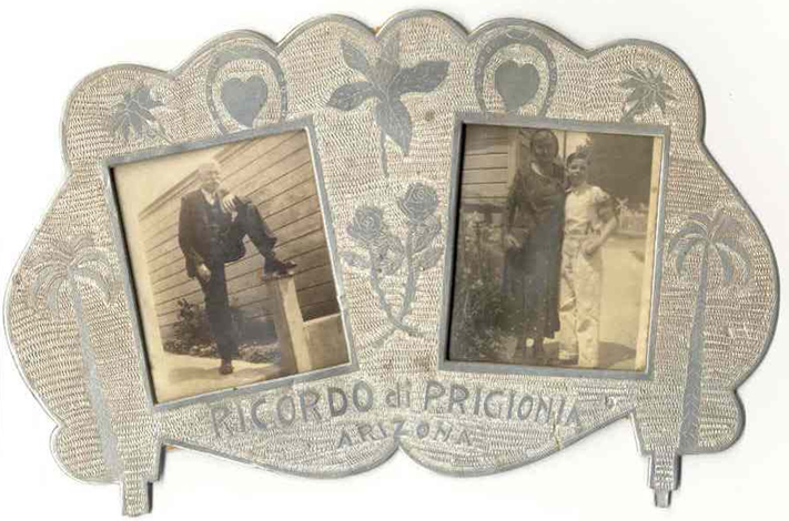 A homemade picture frame decorated with plants, hearts, horseshoes, and the words Ricordo di Prigonia Arizona with photos of William Henry with a leg propped up on a column and Bertha with her arm around her son Frank
